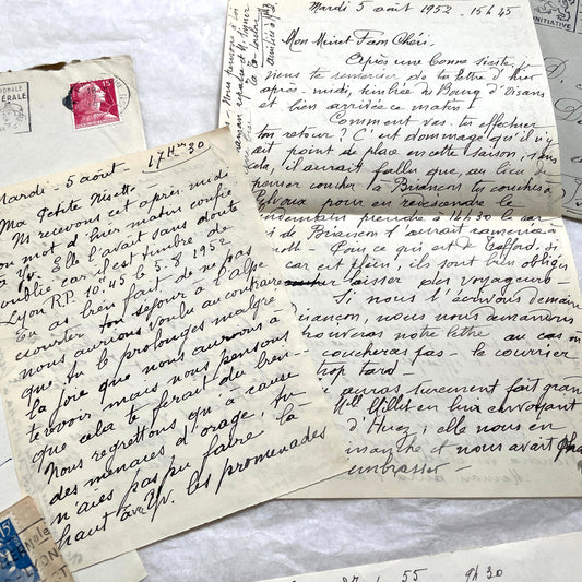Set of 1950s French handwritten letters with envelopes, showing elegant script and vintage stamps.