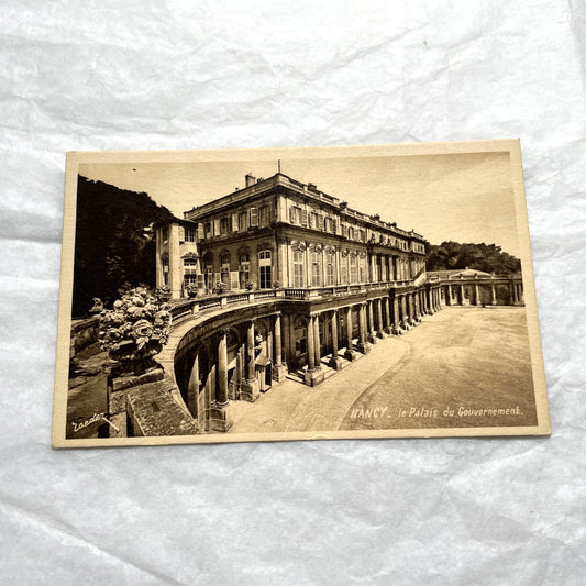 1910s French postcard lot of Nancy landmarks, including Place Stanislas and Palais du Gouvernement, in sepia tone.
