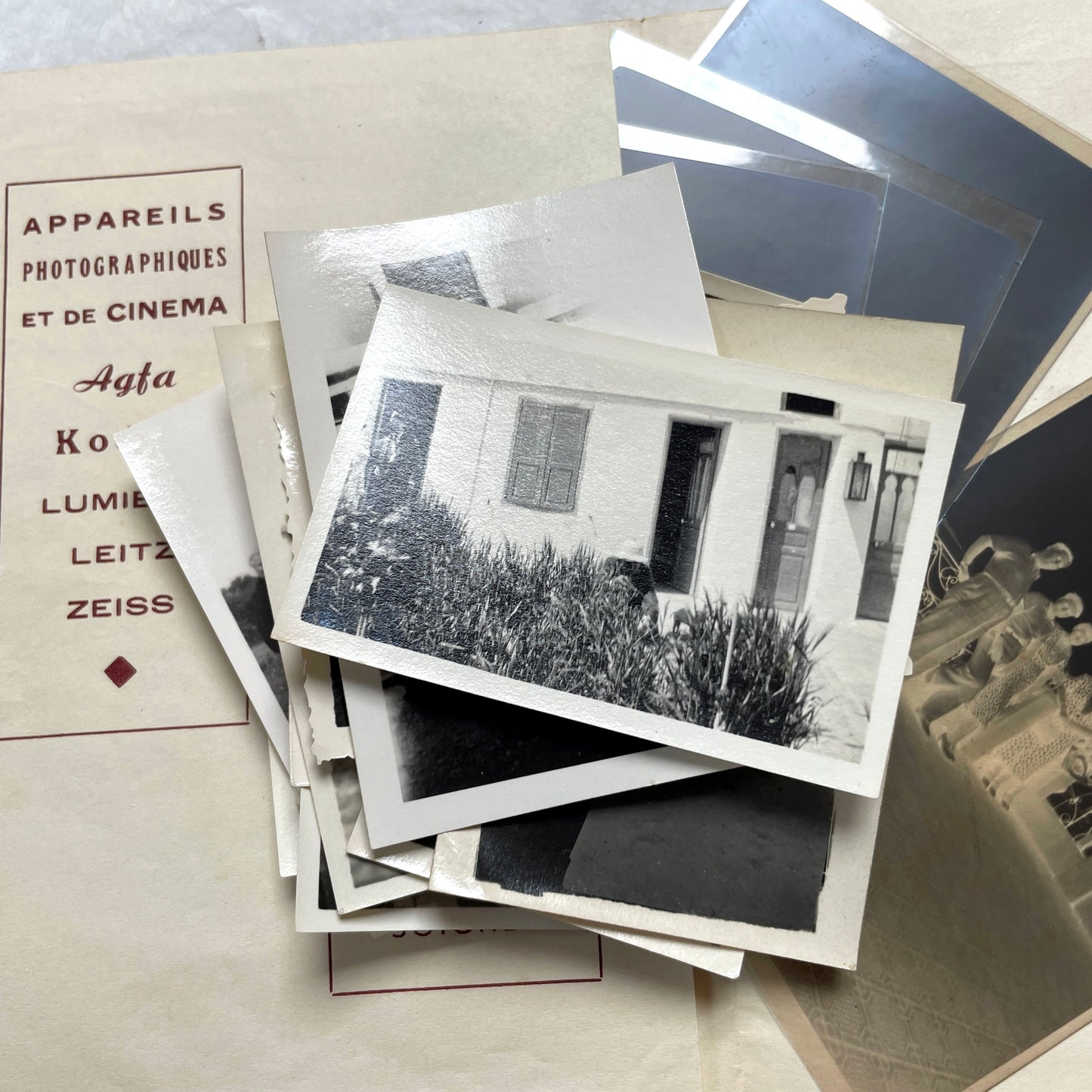 1930s vintage photograph lot showing French family life, travel, skiing, beach scenes, and a vintage car.