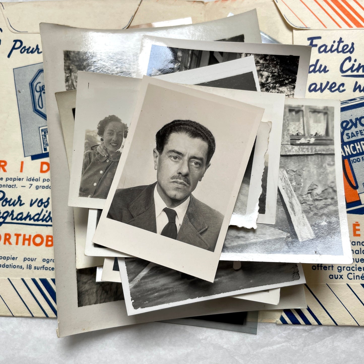 1930s French vintage photographs lot with Gevaert film and paper ephemera, showing everyday life and advertisements.
