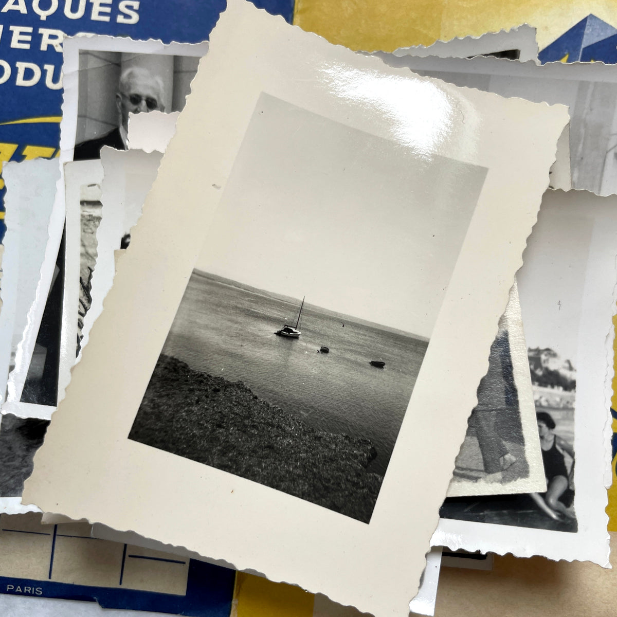 1930s vintage French photo lot with black and white pictures of family, children on the beach, and elegant couples.