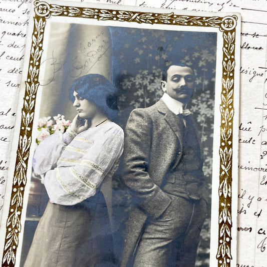 1900s - Vintage French Hand-Colored Photo Postcard - Belle Epoque Couple - 'Après La Pluie' Caption - Ornate Gold Border