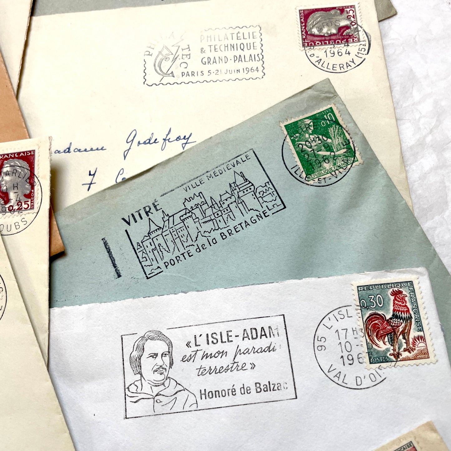 A collection of 20 French envelopes from the 1960s, featuring various postage stamps and unique regional postmarks.