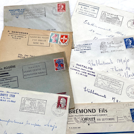 1960s French envelope lot featuring various postmarks, vintage stamps, and printed company addresses.
