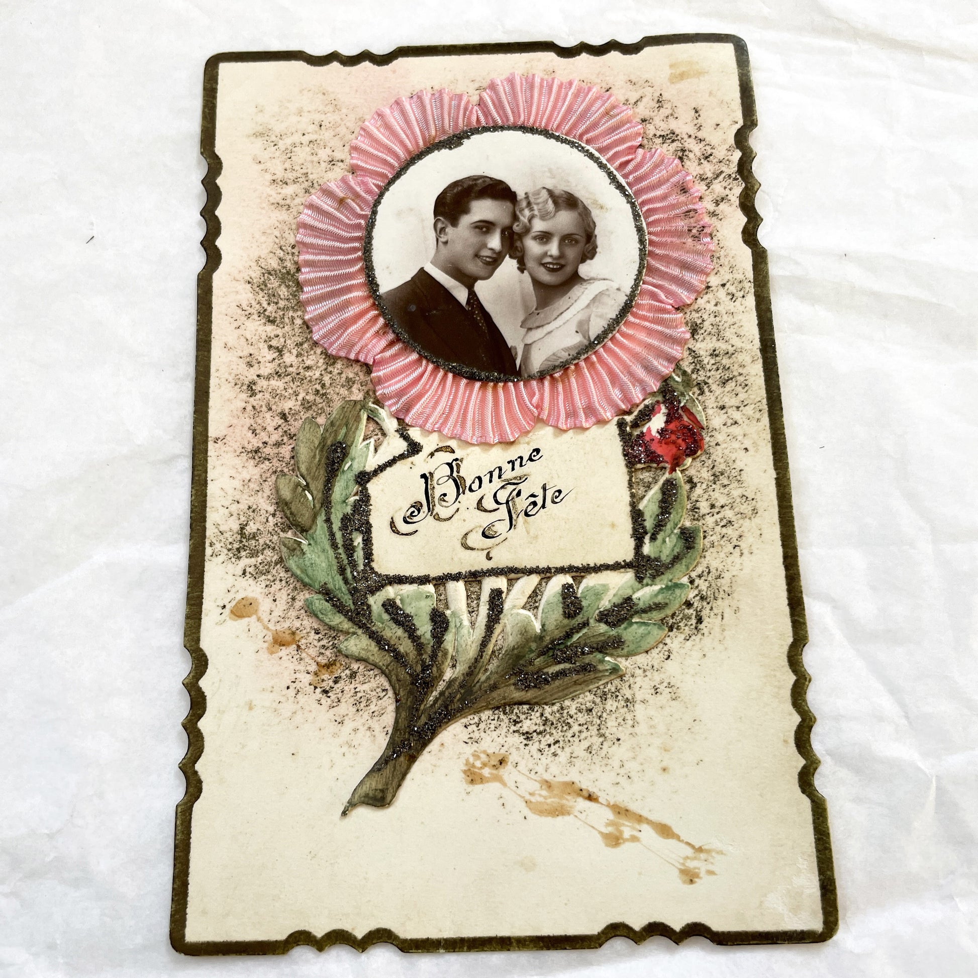 1930s - Vintage French Bonne Fête Greeting Card - Young Couple Photo - Embossed Pink Ribbon - Green Glitter Laurel - Keepsake Ephemera