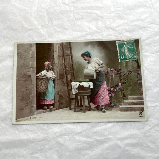 Lot of 6 1910s French postcards depicting women washing laundry in a village setting with visible French stamps.