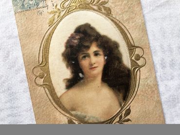 French embossed postcard representing a painting of a young girl in a beautiful medallion in Art Nouveau style - 1900s