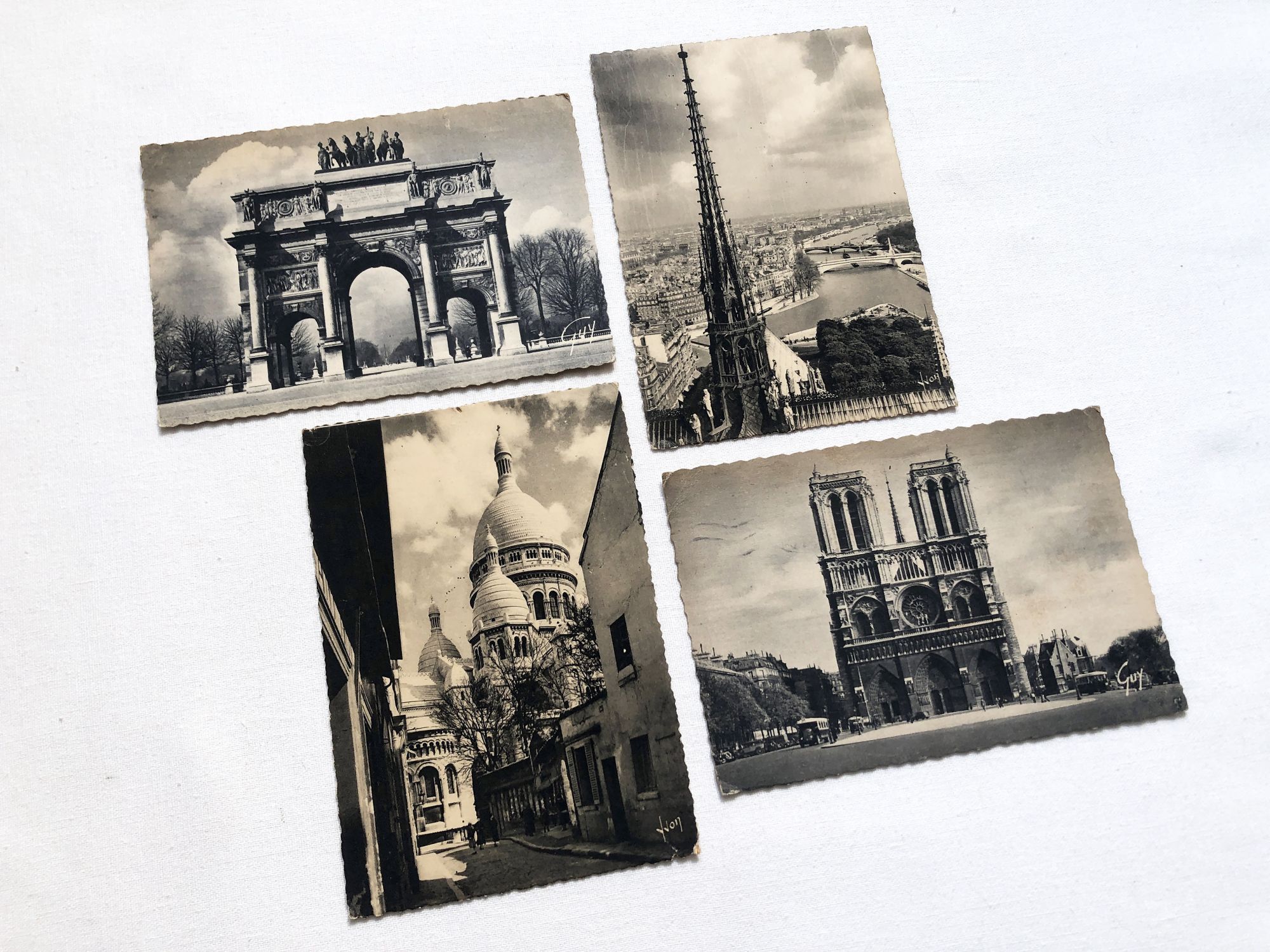 Set of 4 Vintage French postcards of Paris from 1950s with Notre-Dame, the Sacré-Coeur and the Carroussel du Louvre.