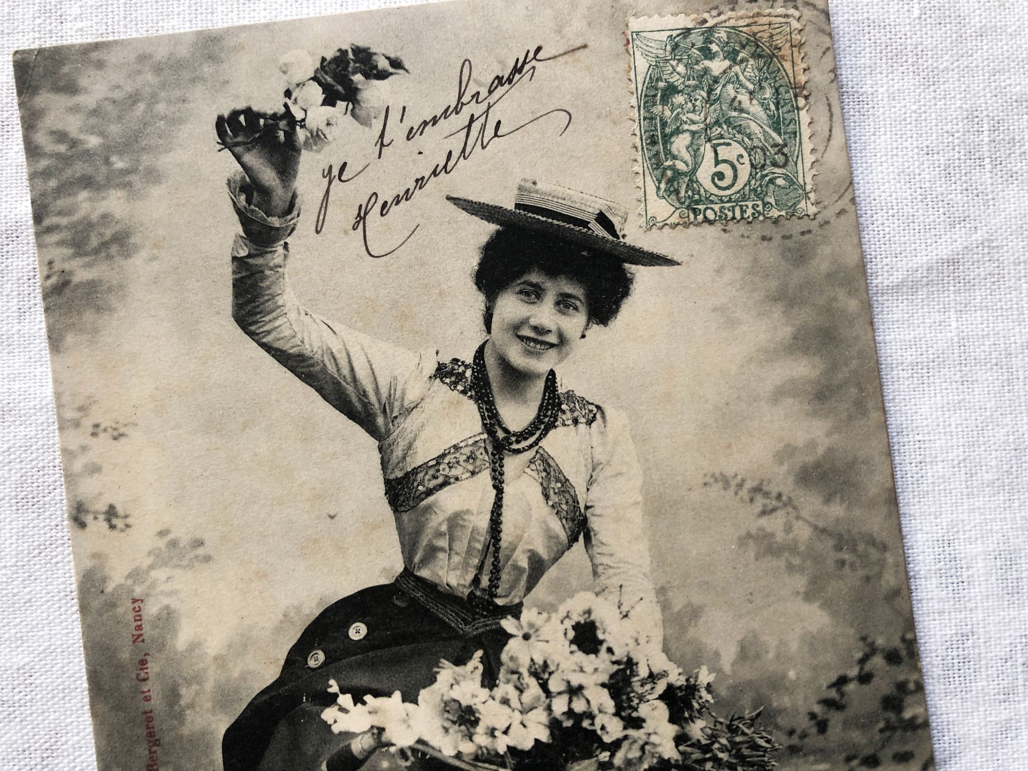 French postcard representing a young woman on a bicycle from 1900s