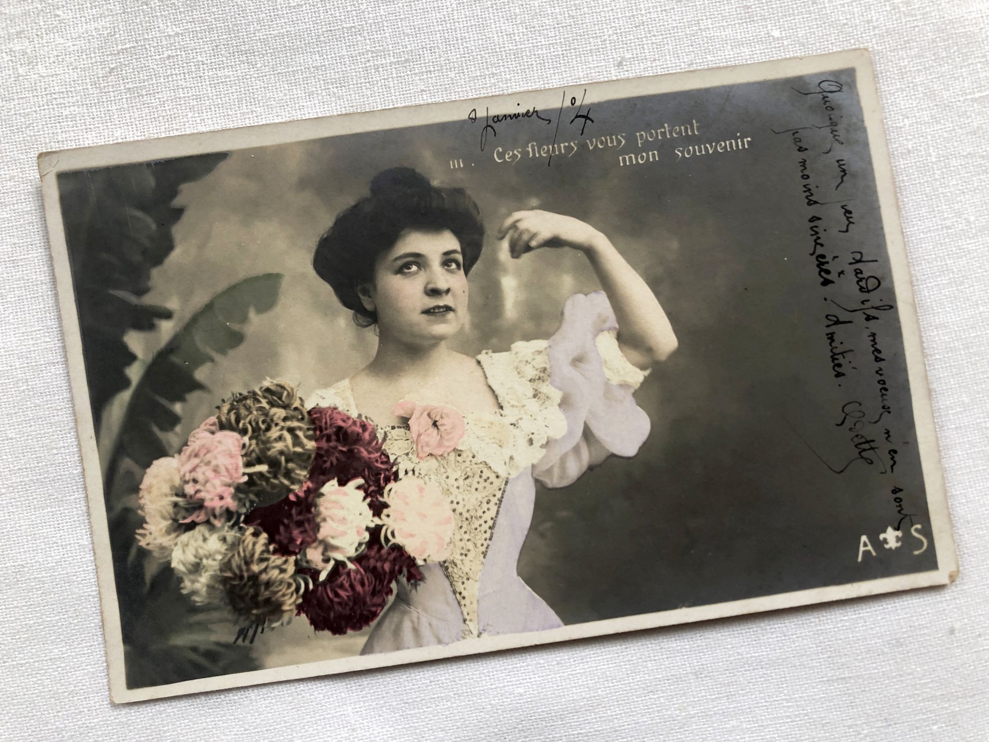 French vintage postcard representing a young woman with flowers from 1910s
