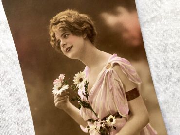 French birthday postcard representing a young women with flowers from 1910s