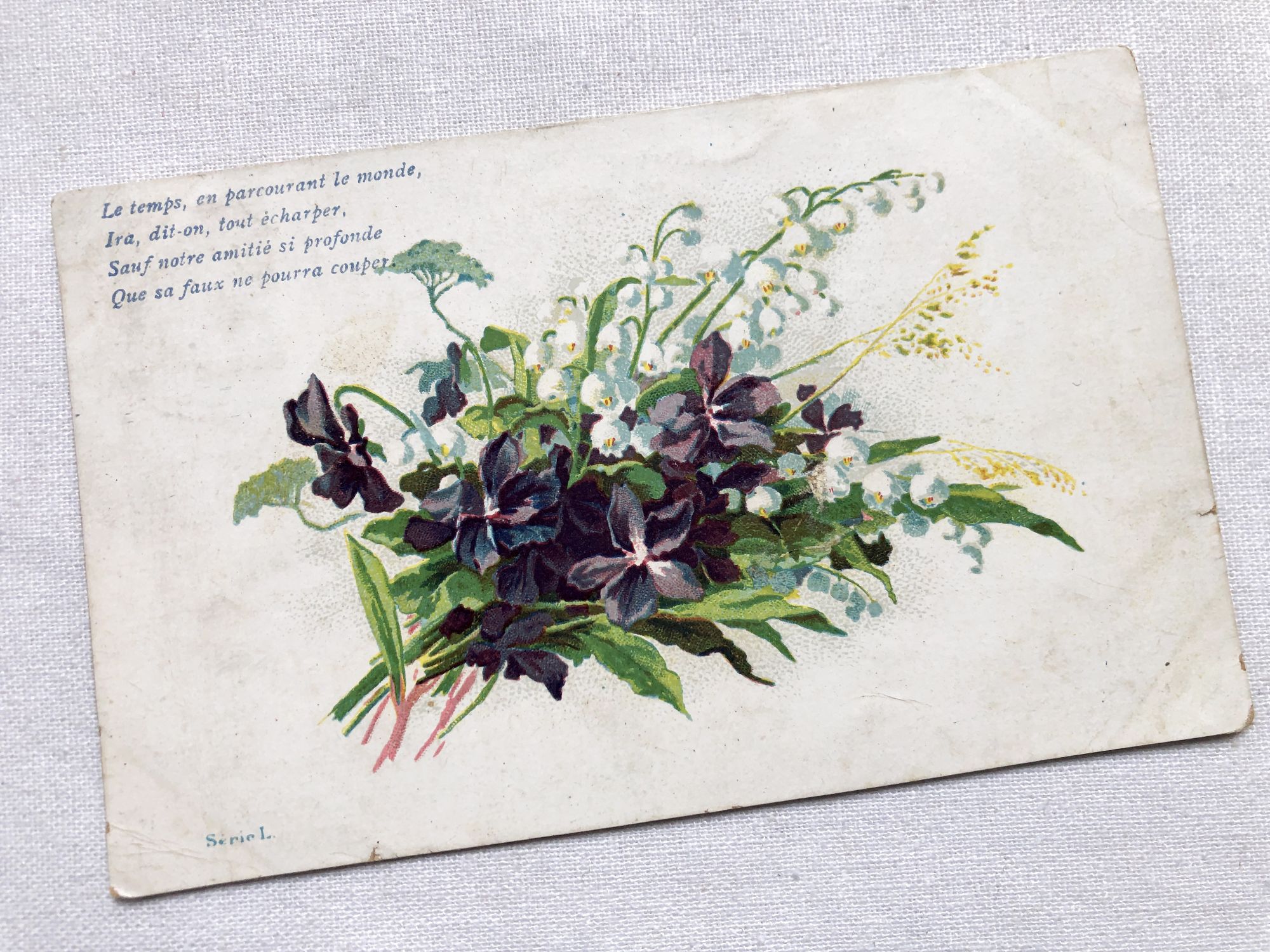 Vintage French postcard with a small bouquet of lily of the valley from 1900s