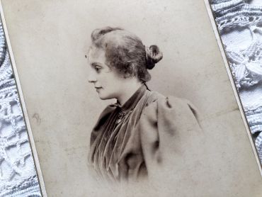 Beautiful photographic portrait of a young woman of the early twentieth century with richly decorated back