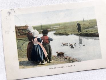 Belgian postcard of a group of children playing around a duck pond from 1910s