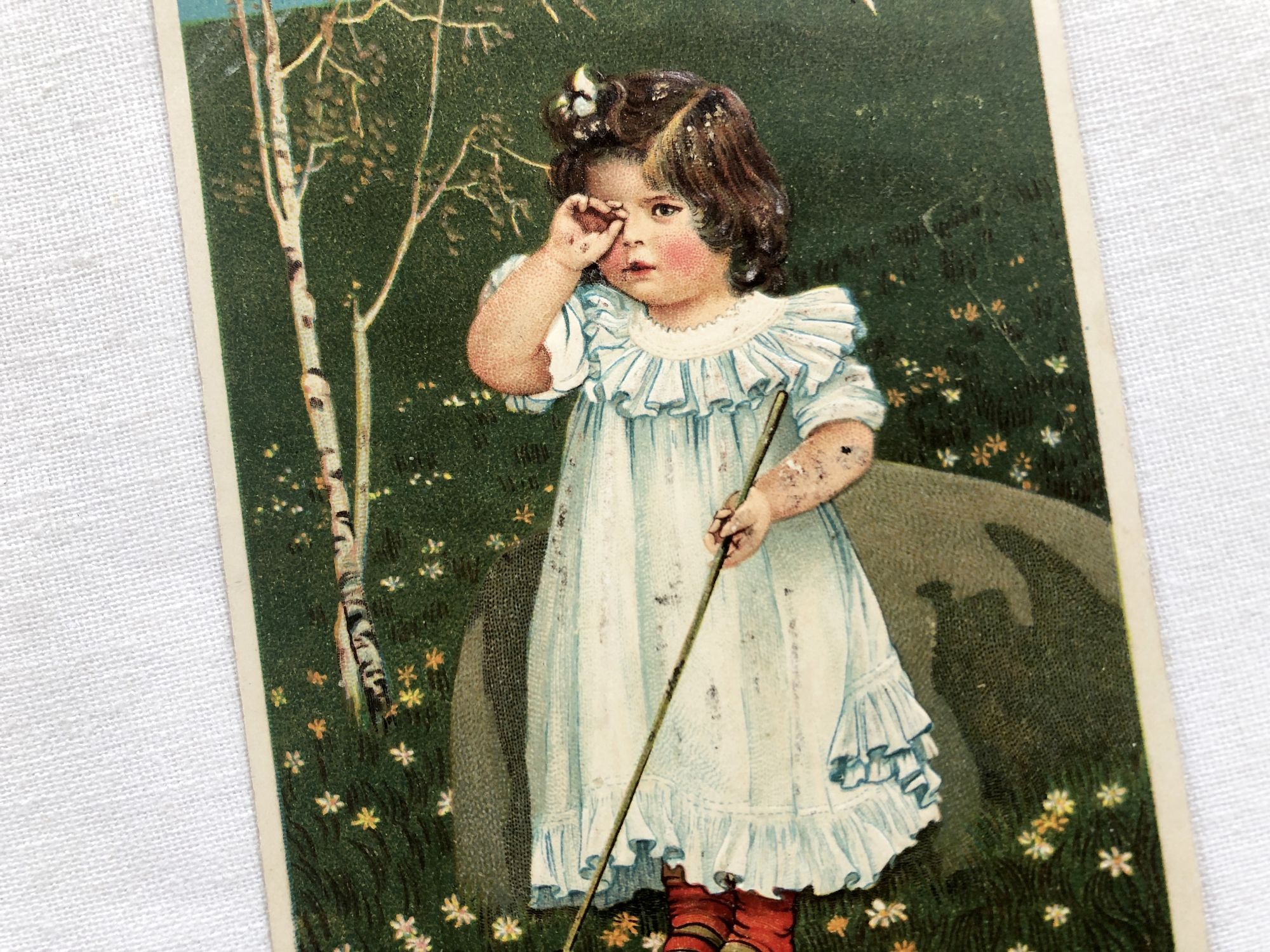 Embossed Belgian postcard depicting a little girl chasing butterflies from 1900s