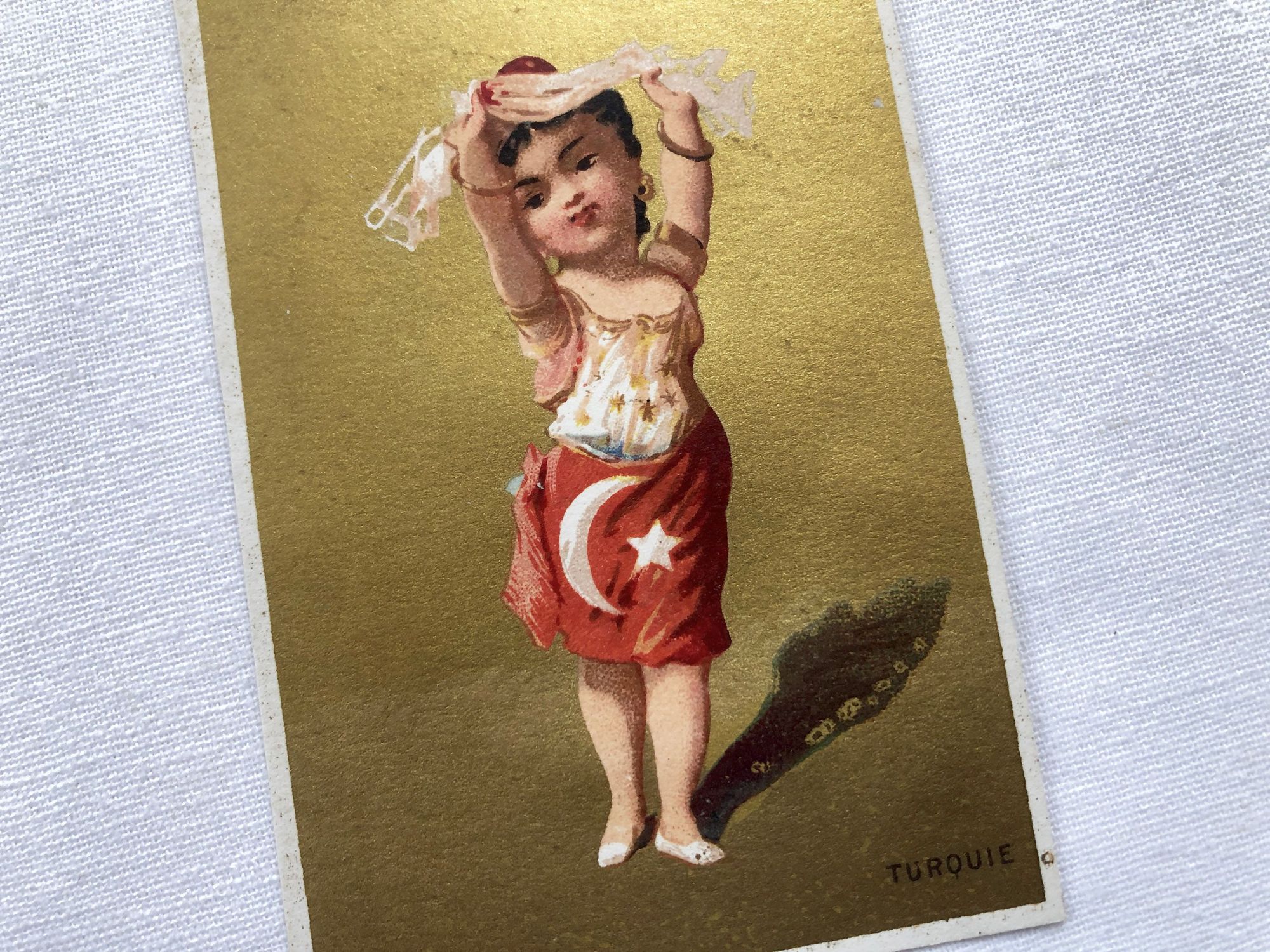 Vintage French chromolithograph with a young lady representing Turkey with golden background from 1890s