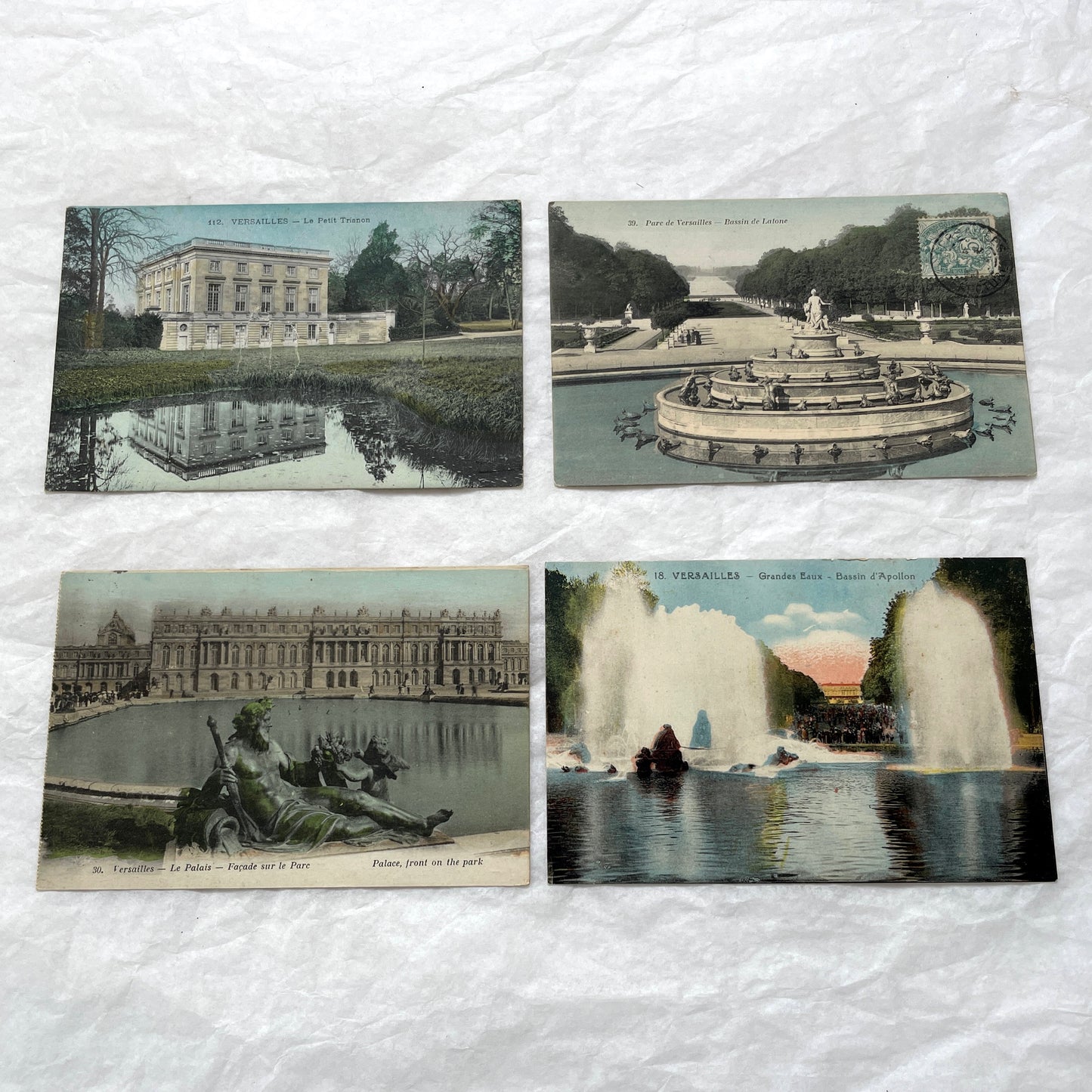 1910s French postcards lot featuring Versailles Palace, Petit Trianon, and grand fountains like Latona and Apollo's Basin.