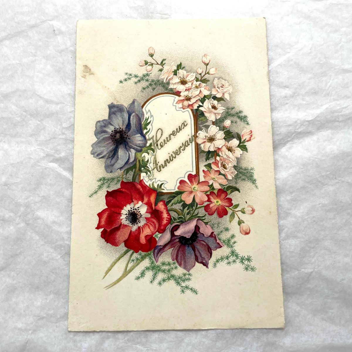 Two 1910s vintage French postcards featuring colorful floral designs, one with anemones for birthday, another with roses in a