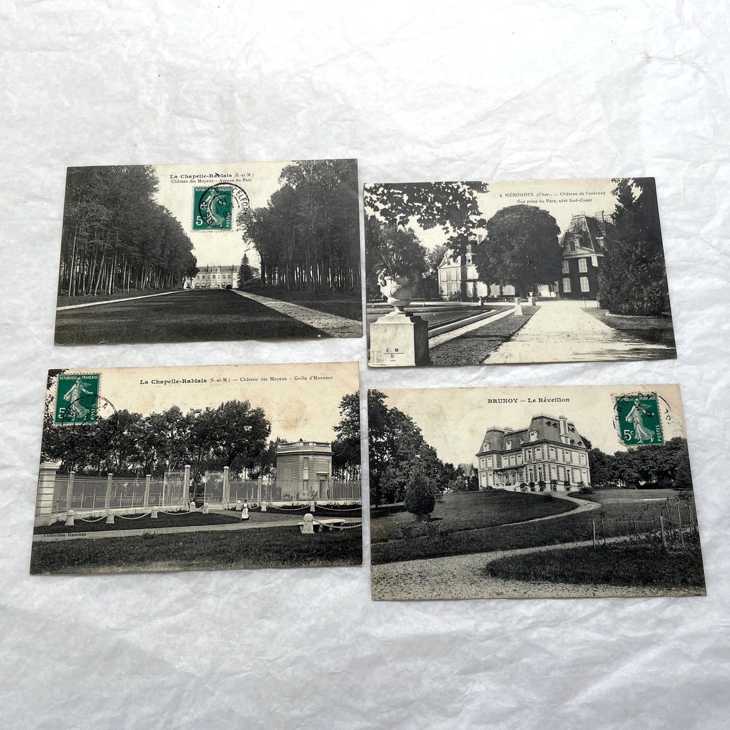 Lot of four 1910s French postcards showing black and white photographs of châteaux and grand estates in France.