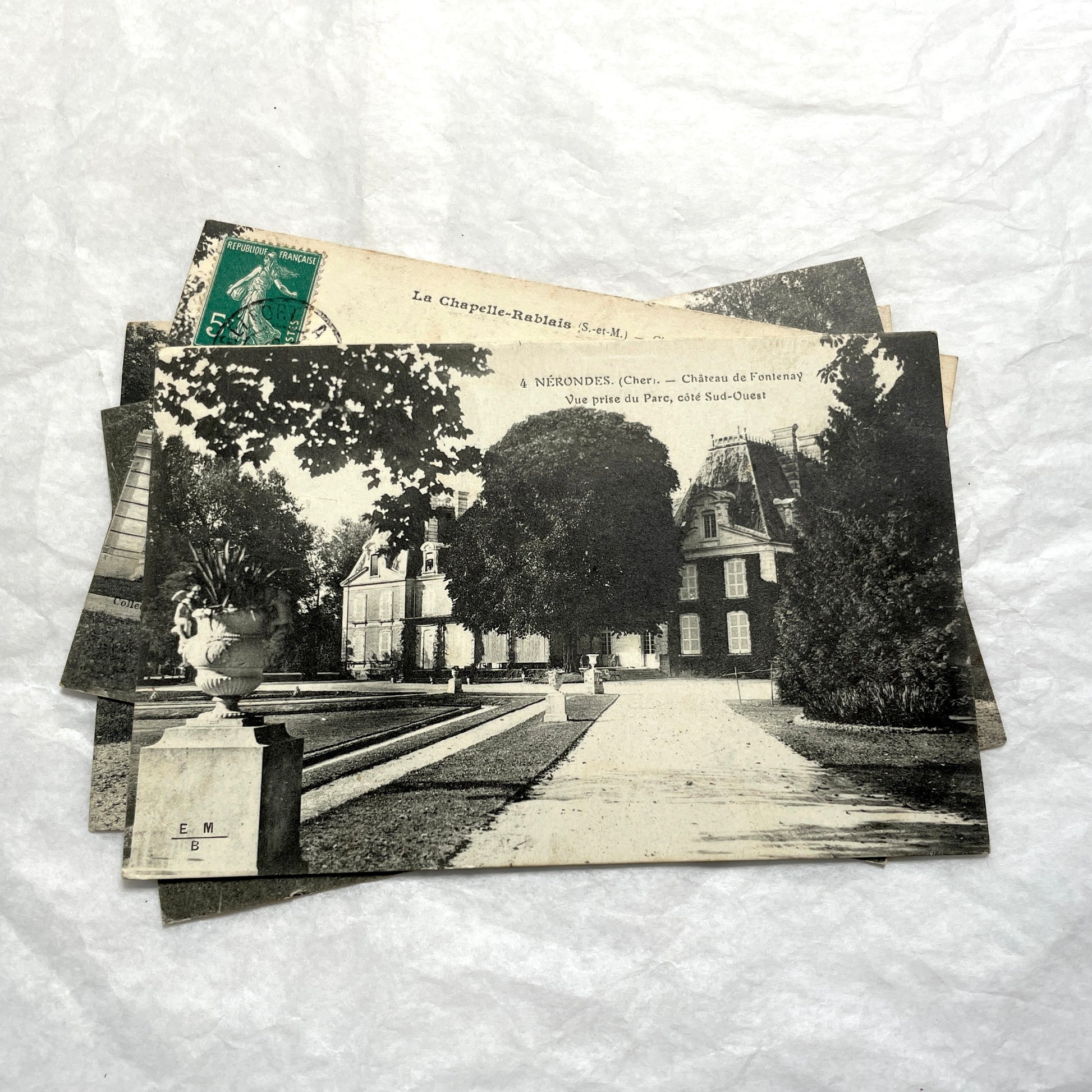 Lot of four 1910s French postcards showing black and white photographs of châteaux and grand estates in France.