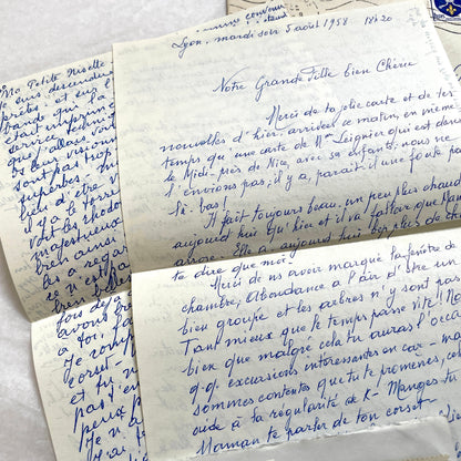 Set of 1950s French handwritten letters and envelopes with stamps. Vintage paper ephemera for collectors.