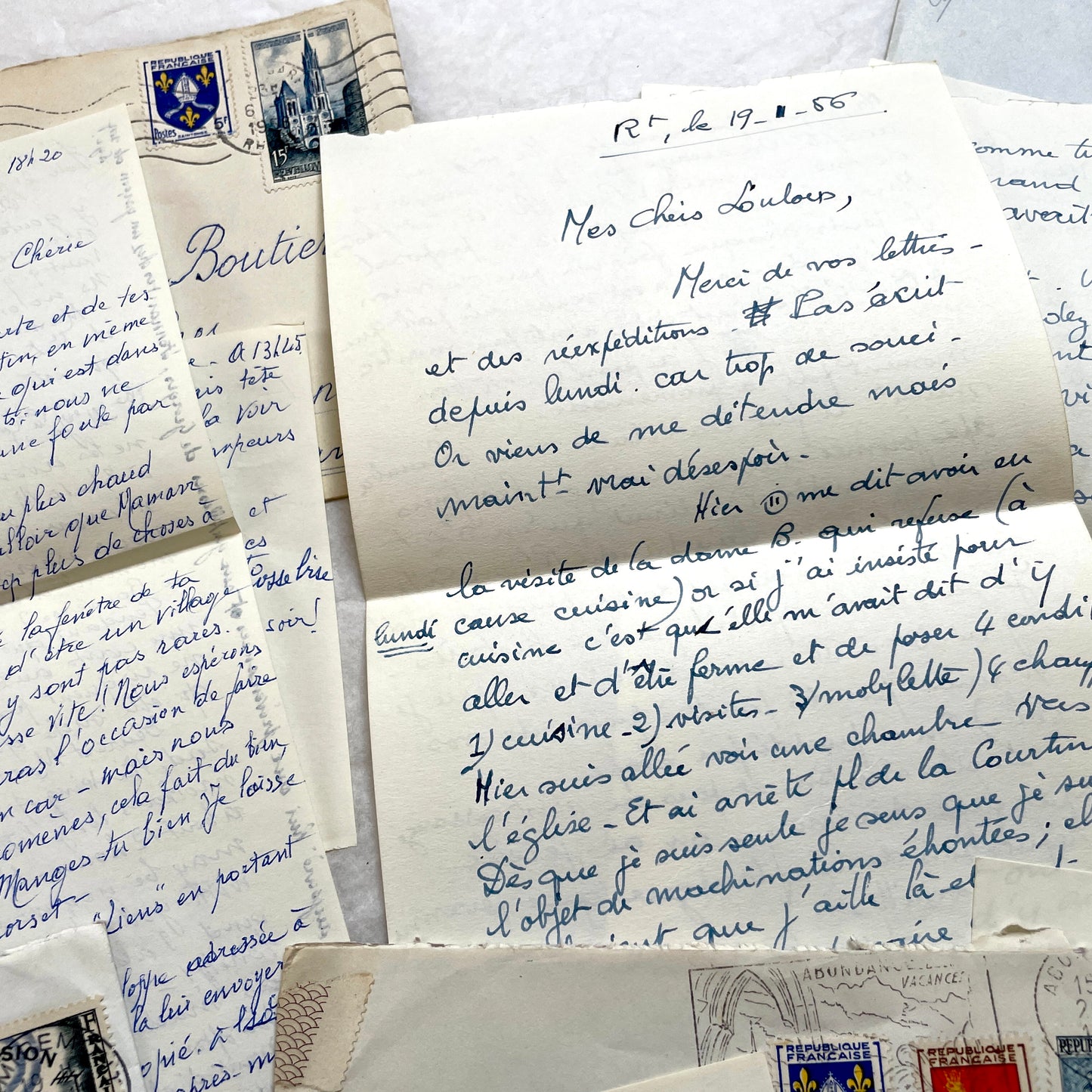 Set of 1950s French handwritten letters and envelopes with stamps. Vintage paper ephemera for collectors.