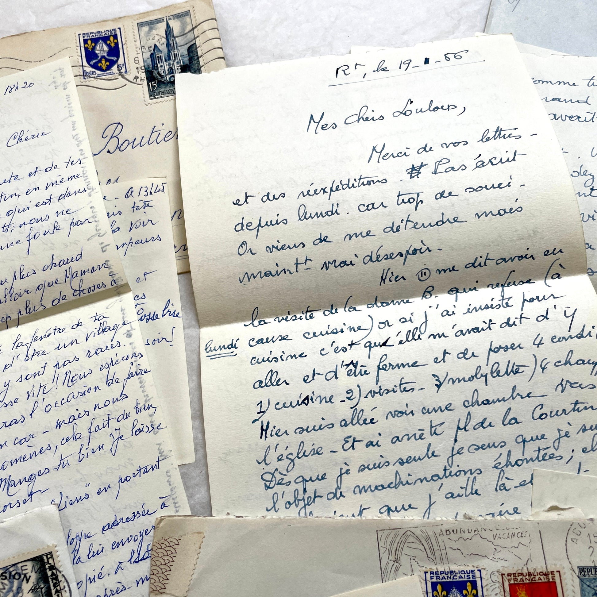 Set of 1950s French handwritten letters and envelopes with stamps. Vintage paper ephemera for collectors.