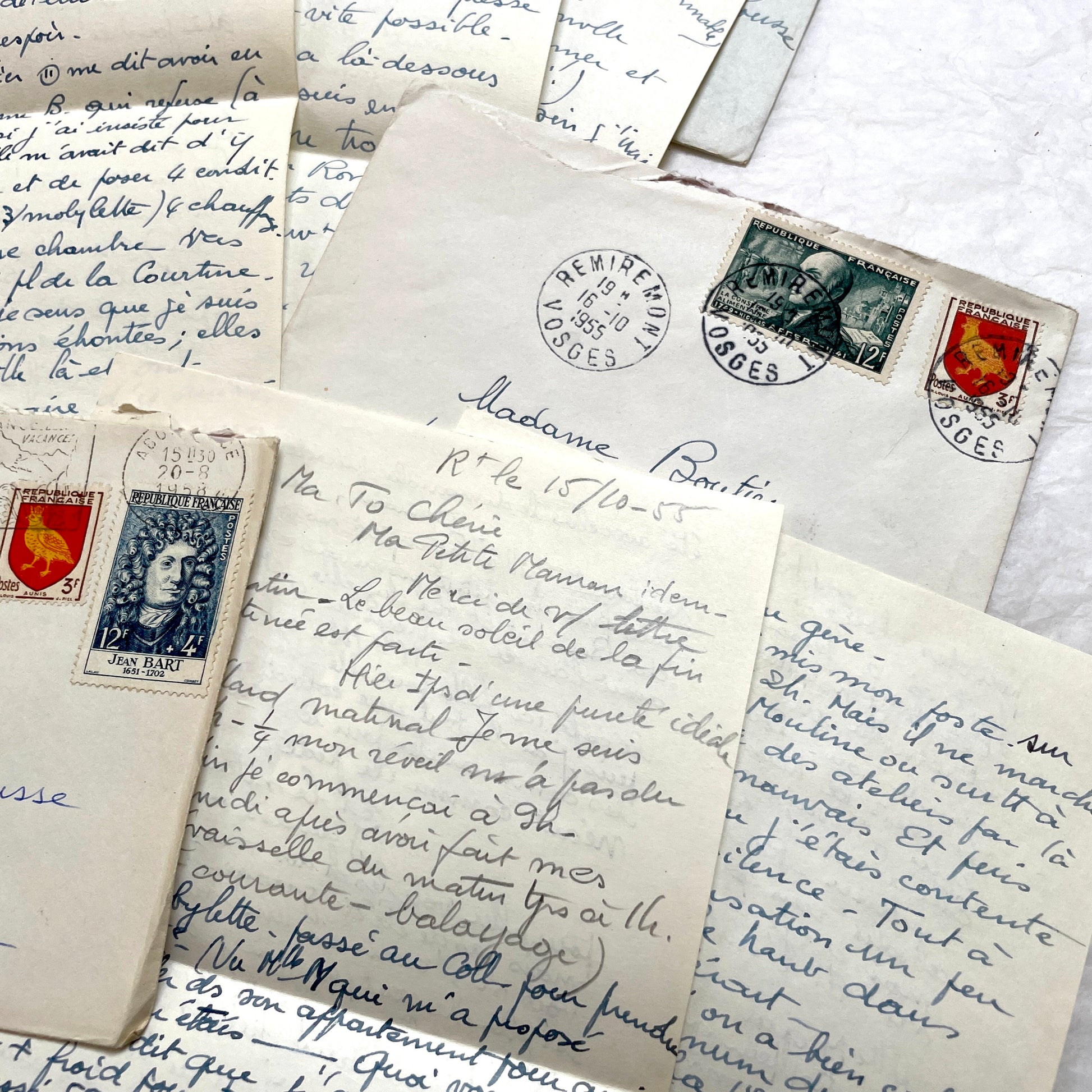Set of 1950s French handwritten letters and envelopes with stamps. Vintage paper ephemera for collectors.