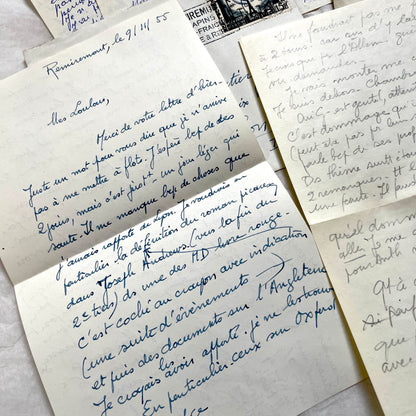 Set of 1950s French handwritten letters and envelopes with stamps. Vintage paper ephemera for collectors.