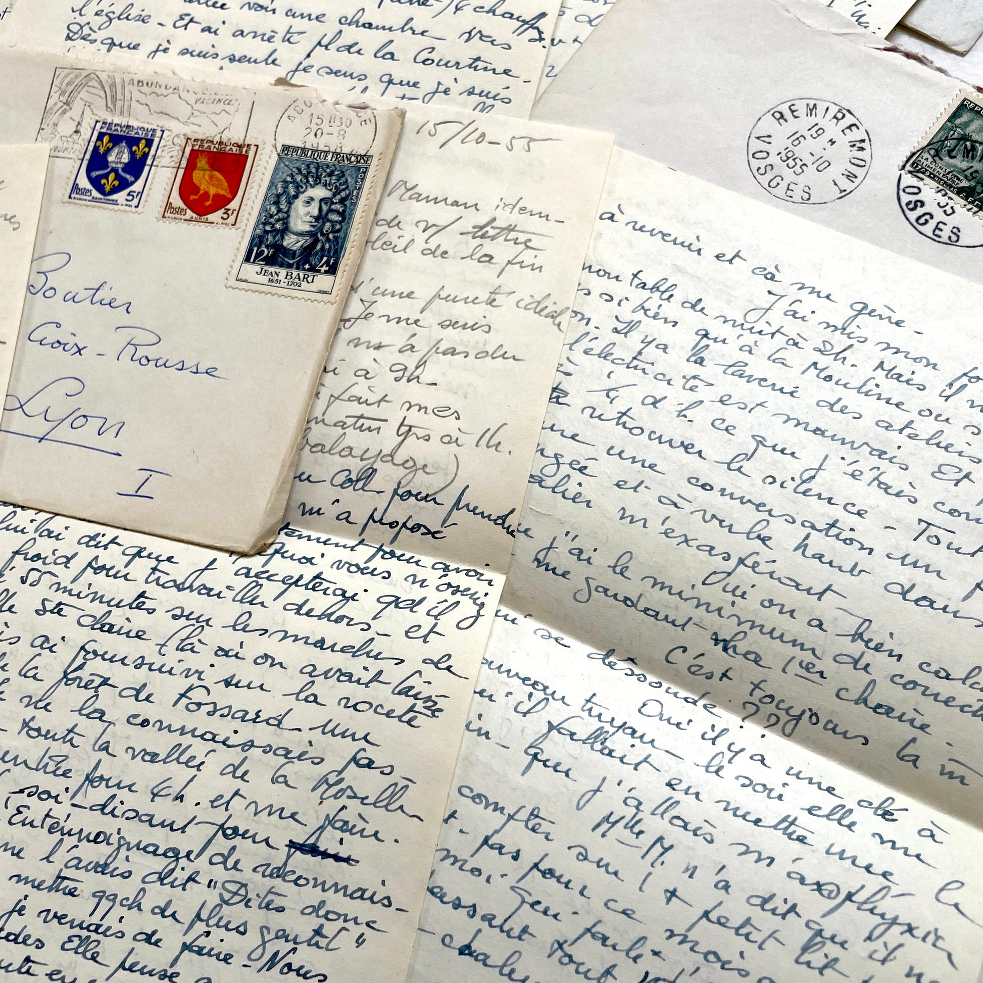 Set of 1950s French handwritten letters and envelopes with stamps. Vintage paper ephemera for collectors.