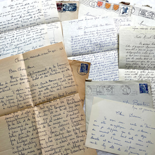 1950s French handwritten letters set with envelopes, vintage stamps, and postmarks. Historical correspondence.