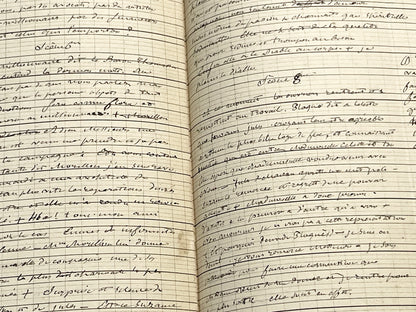 Late 19th French play script manuscript showing neat handwritten text in a vintage ledger book.
