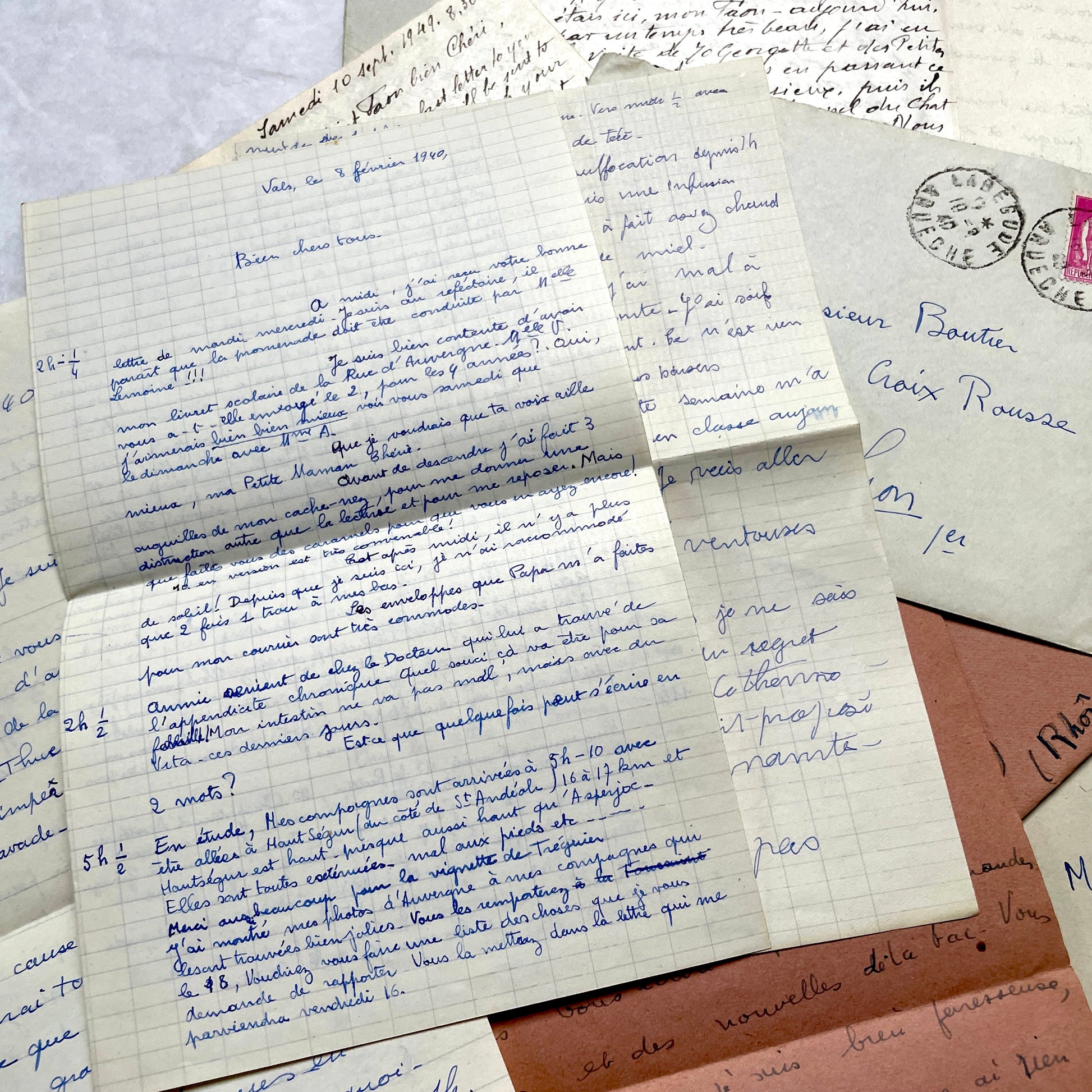 Set of 1940s vintage French letters with envelopes, featuring handwritten text, original stamps, and postmarks.
