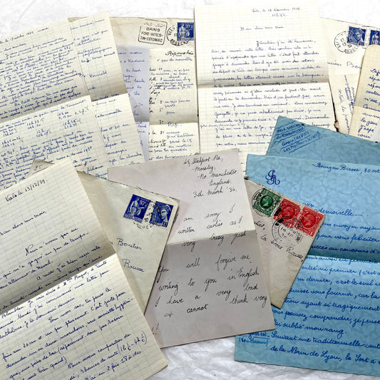Set of 1930s vintage letters and envelopes with French and English handwriting and period stamps, historical ephemera.