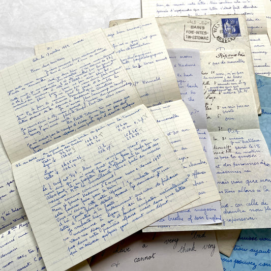 Set of 1930s vintage letters and envelopes with French and English handwriting and period stamps, historical ephemera.