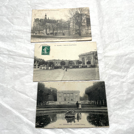 Lot of three 1900s French postcards showing Versailles Grand Trianon, Petit Trianon, and a Paris Montparnasse view.