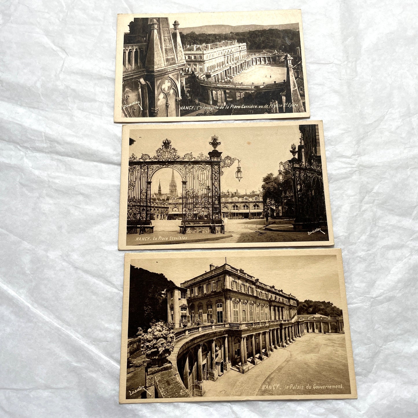 1910s French postcard lot of Nancy landmarks, including Place Stanislas and Palais du Gouvernement, in sepia tone.