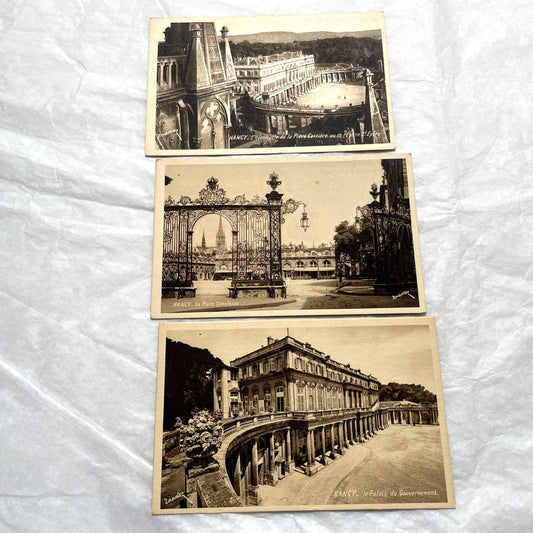 1910s French postcard lot of Nancy landmarks, including Place Stanislas and Palais du Gouvernement, in sepia tone.