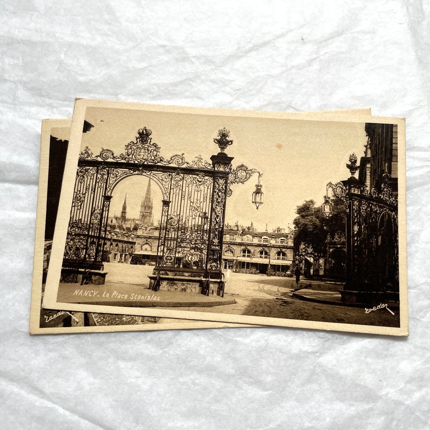 1910s French postcard lot of Nancy landmarks, including Place Stanislas and Palais du Gouvernement, in sepia tone.