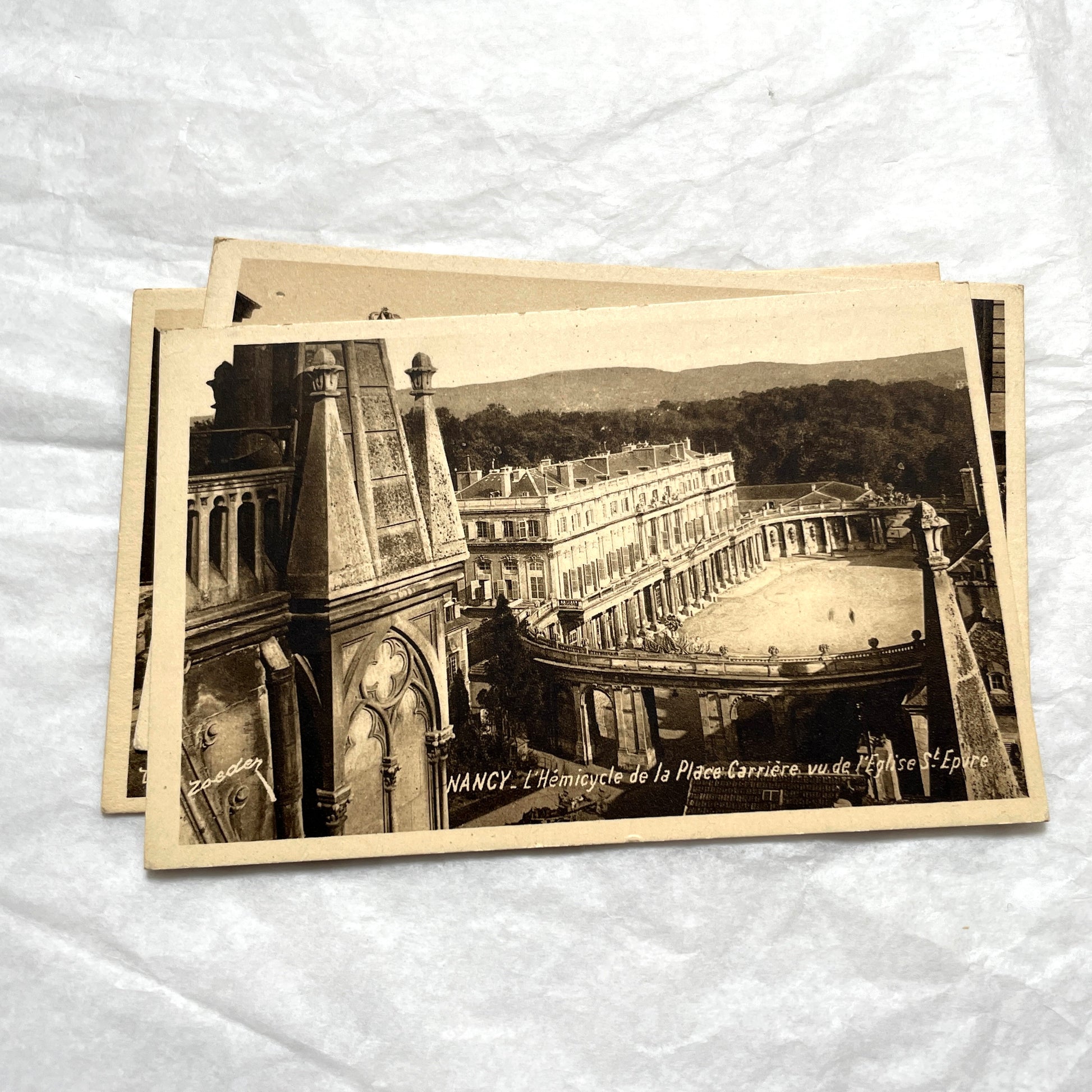 1910s French postcard lot of Nancy landmarks, including Place Stanislas and Palais du Gouvernement, in sepia tone.
