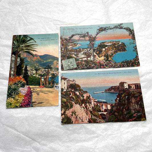 Vintage 1920s French postcard lot of Monaco and Monte-Carlo, featuring scenic coastal views with lush flowers and palm trees.