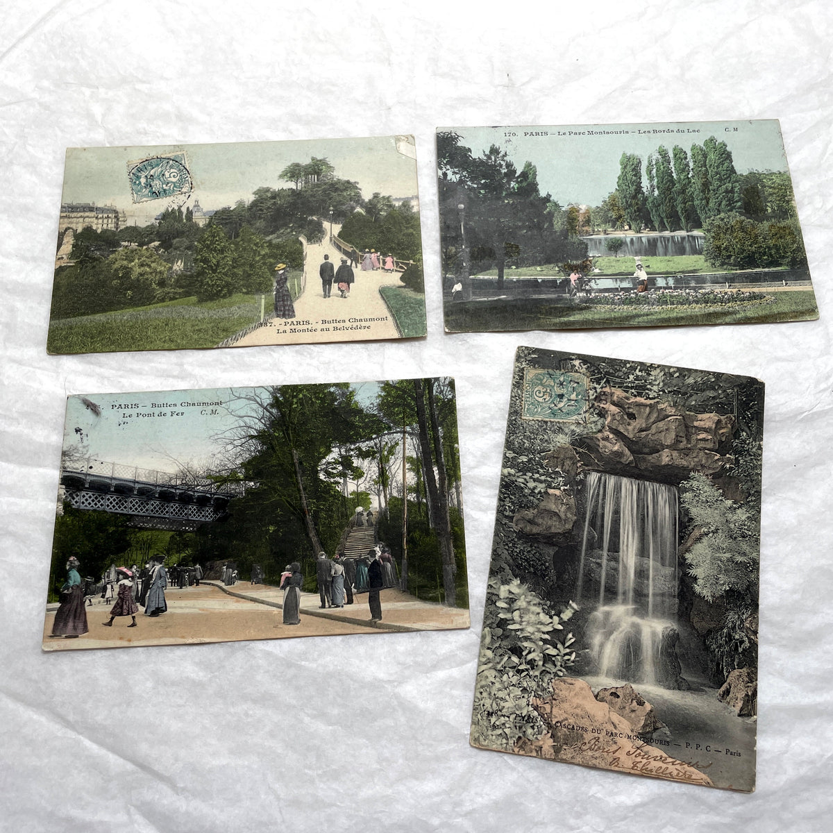 1900s French postcards lot featuring Parisian park scenes from Buttes Chaumont and Parc Montsouris with people.