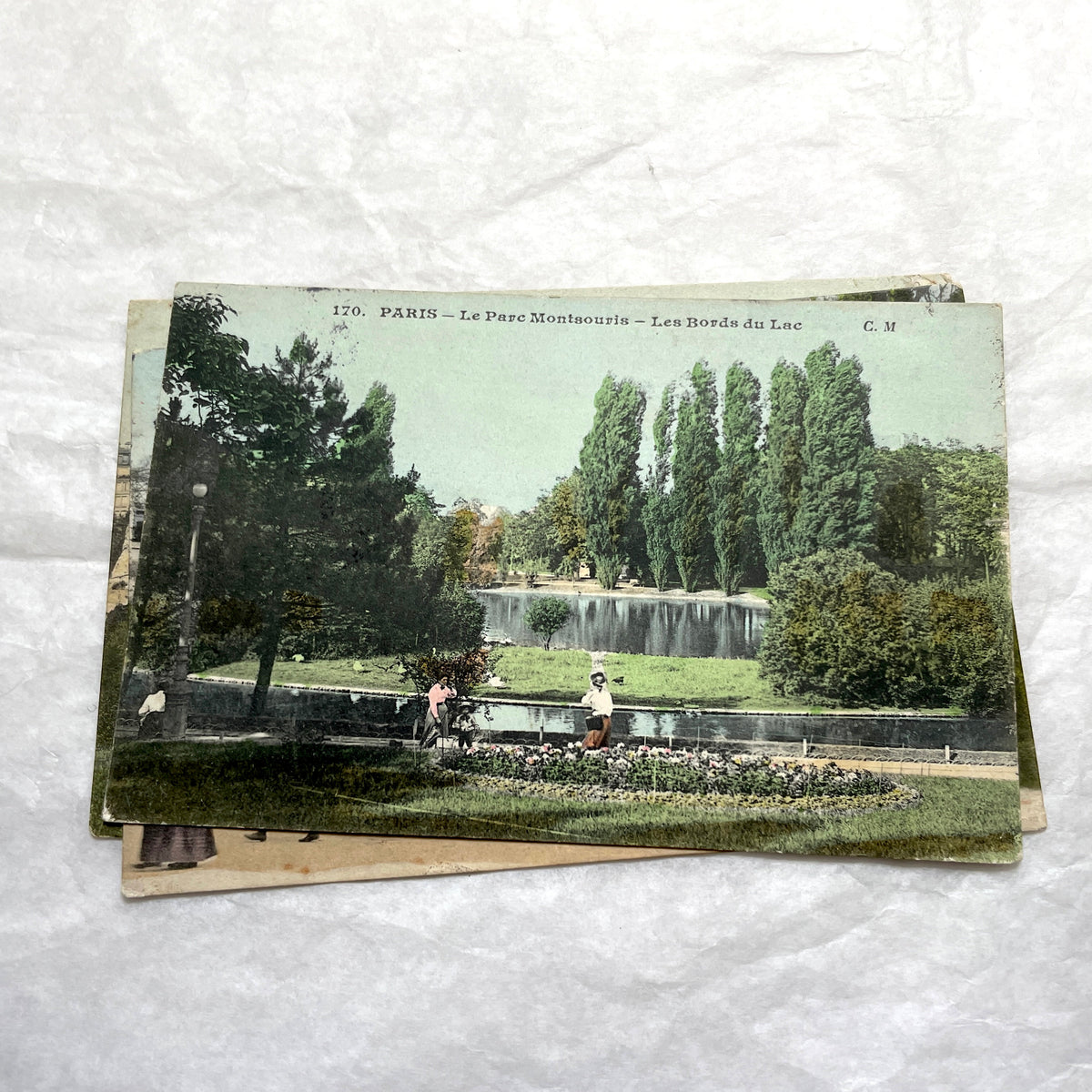 1900s French postcards lot featuring Parisian park scenes from Buttes Chaumont and Parc Montsouris with people.