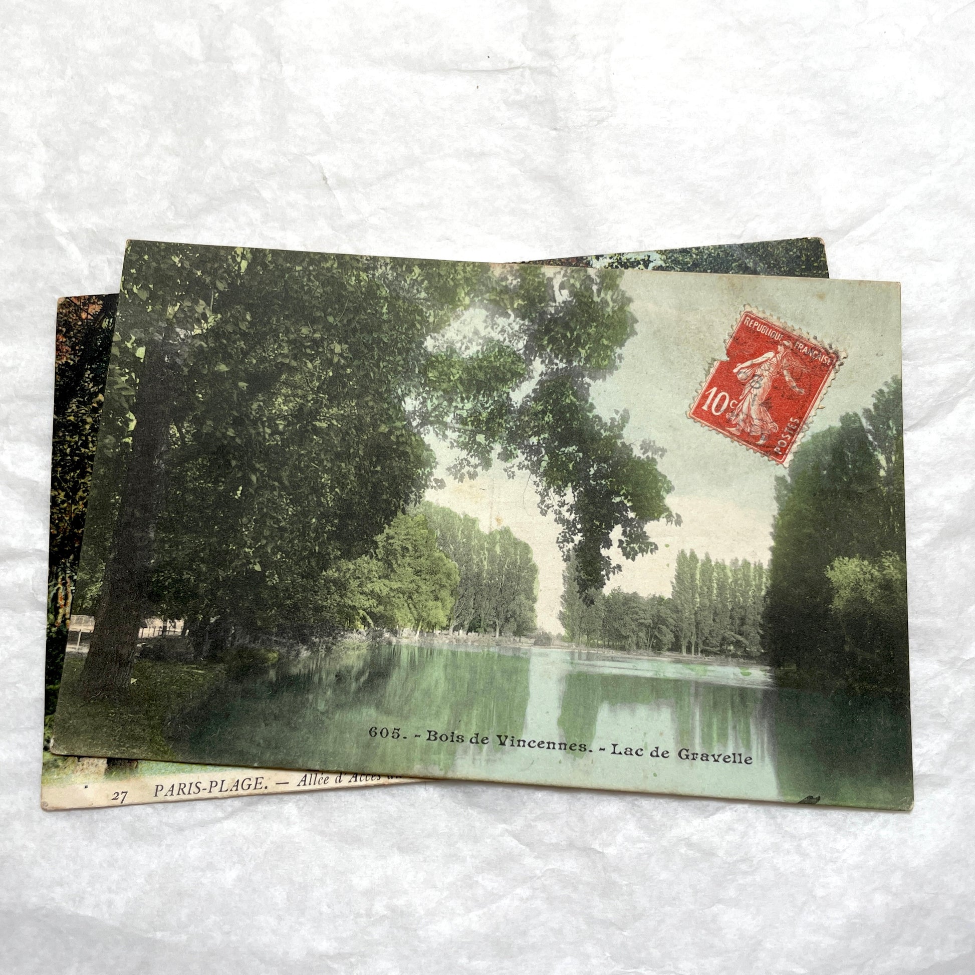 1900s French postcard lot featuring Bois de Vincennes lake and Paris-Plage alley with a person.