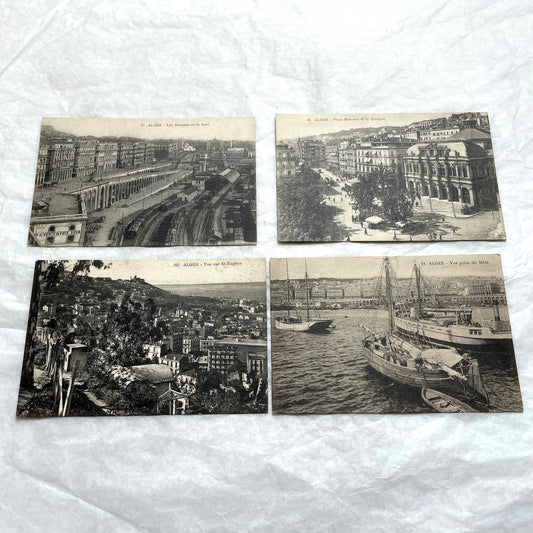 Lot of 1910s Algiers postcards showing French colonial city views, harbor, train station, and theater architecture.