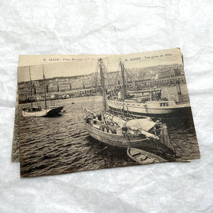 Lot of 1910s Algiers postcards showing French colonial city views, harbor, train station, and theater architecture.