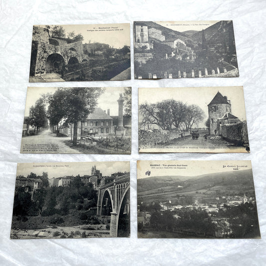 Lot of 1910s French postcards showing historic village scenes, old ramparts, a bridge, and a tower in France.