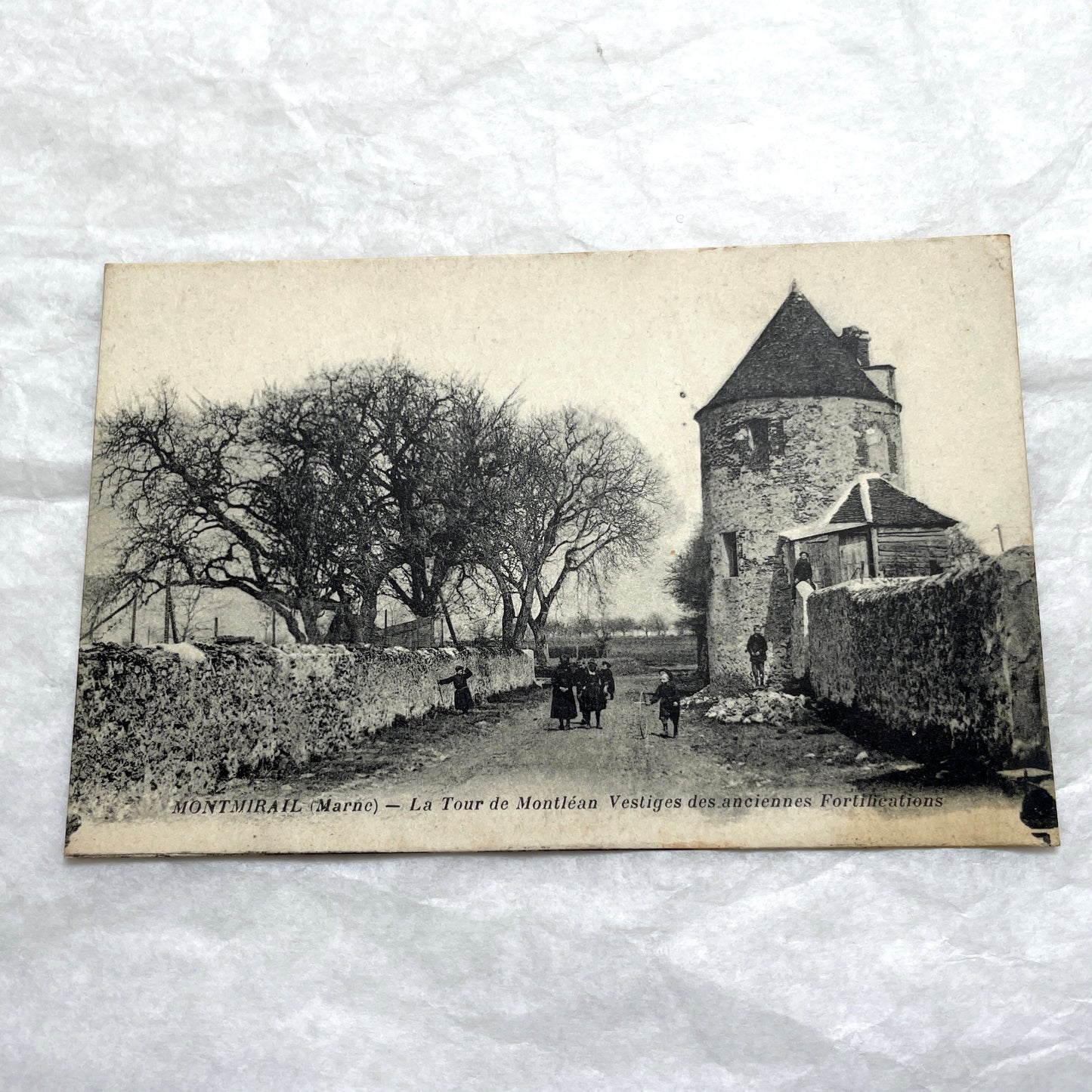 Lot of 1910s French postcards showing historic village scenes, old ramparts, a bridge, and a tower in France.