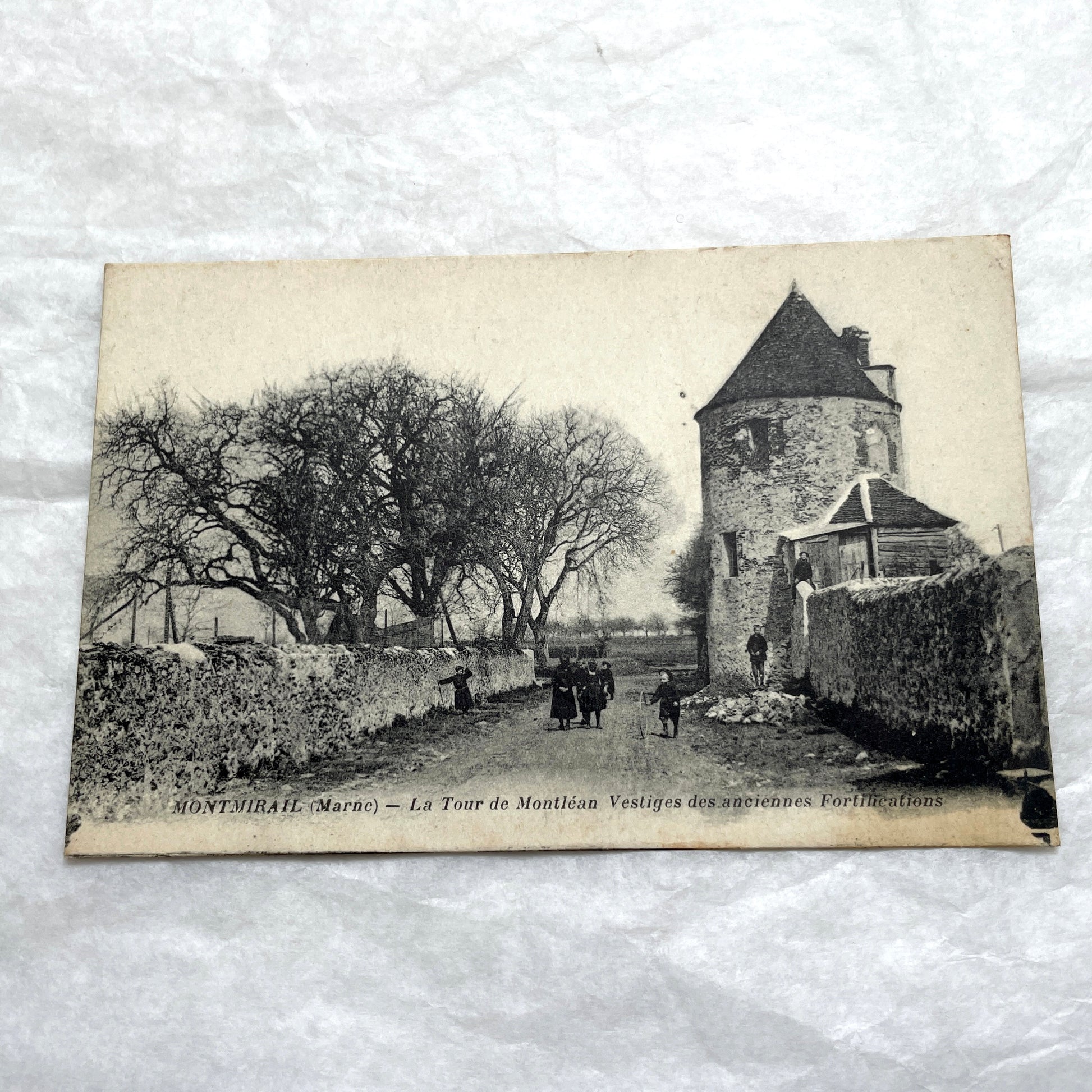 Lot of 1910s French postcards showing historic village scenes, old ramparts, a bridge, and a tower in France.