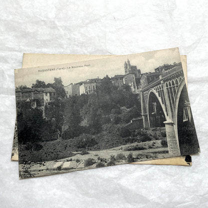 Lot of 1910s French postcards showing historic village scenes, old ramparts, a bridge, and a tower in France.